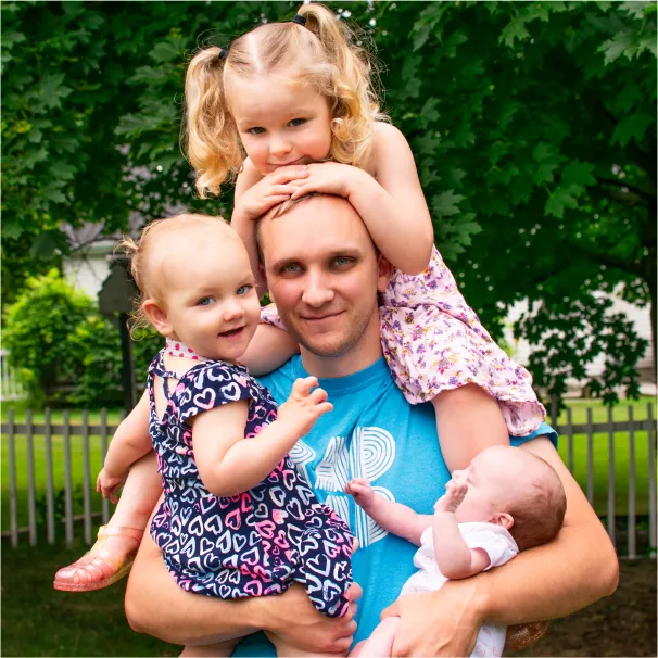 dad and girls smiling